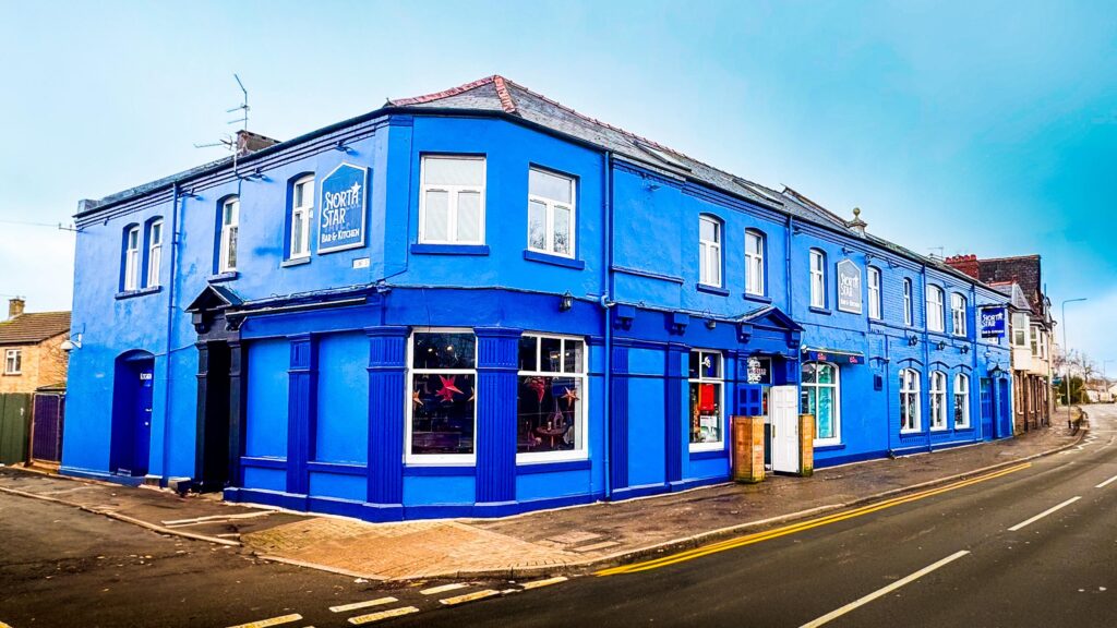 North Star pub exterior on North Road, Cardiff with nearby bus stop.